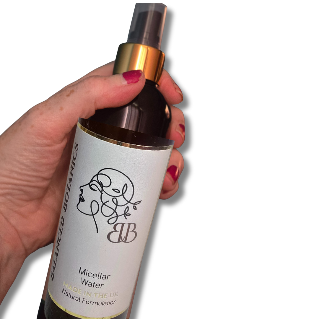 Hand holding a bottle of 'BB Botanics' micellar water with a white background