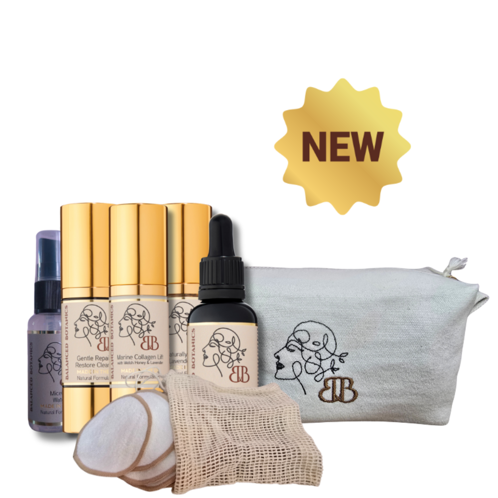 Cosmetic set with gold bottles, a dropper bottle, and a pouch on a white background.