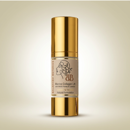 Balanced Botanics Marine Collagen Lift serum in a cylindrical gold bottle with a clear middle section showing the beige-colored serum inside, set against a soft beige gradient background.
