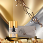 Cosmetic products with a decorative pouch on a gold surface, featuring warm lighting.