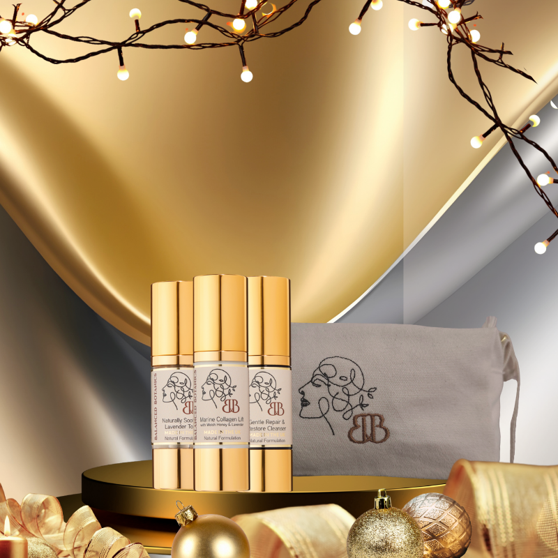 Set of gold cosmetic bottles with a decorative background featuring lights and a pouch.