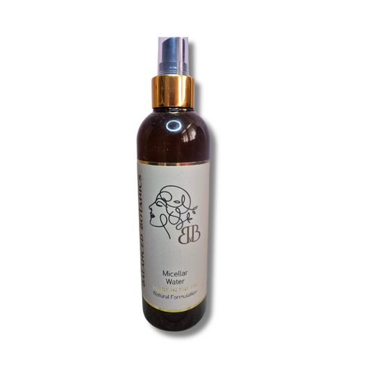 Bottle of micellar water with a gold cap on a white background